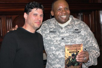 New York Times bestselling author Max Brooks, and New York Army National Guard Col. Reginald Sanders, commander of the 369th Sustainment Brigade, with a copy of Brook's new graphic novel, "The Harlem Hellfighters." The book tells the story of the all-black New York National Guard infantry regiment which fought under French command in World War I and earned more than 170 medals for heroism. Brooks, author of "World War Z," the fictional story of mankind's fight against zombies, visited the Harlem Armory on Feb. 6,  to talk with Sanders about the history of the unit for a National Public Radio book show.