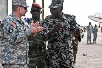 New York Army National Guard Command Sgt. Maj. Justin Lenz, speaks with Malian Army Lt. Abdrahmane Kone during the 369th Sustainment Brigade's deployment to Mali in 2012. The battalion returns to Africa in March to serve as a logistics headquarters for Central Accord 14, a joint exercise being held in Cameroon. This will be the third African exercise the brigade has played a role in. (U.S. Army photo by Staff Sgt. Shana R. Hutchins)