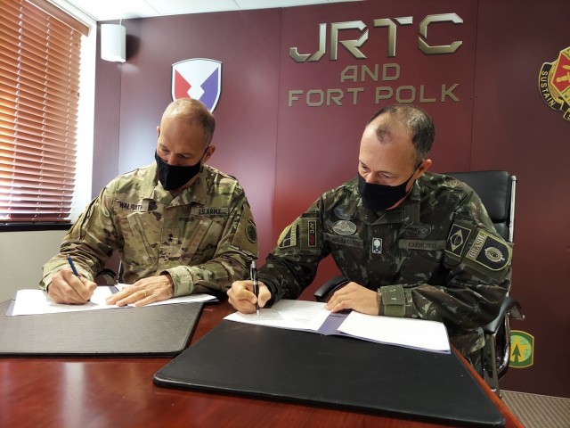Maj. Gen. Daniel R. Walrath, Army South commanding general, left, and Lt. Gen. Marcos de Sá Affonso da Costa, chief of training, Land Forces Training Command, Exército Brasileiro, signs a technical arrangement between the Brazilian Army and the U.S. Army as represented by Army South concerning Brazilian participation in combined training exercise in conjunction with Joint Readiness Training Center Rotation 21-04 at Fort Polk, Louisiana, Feb. 1.