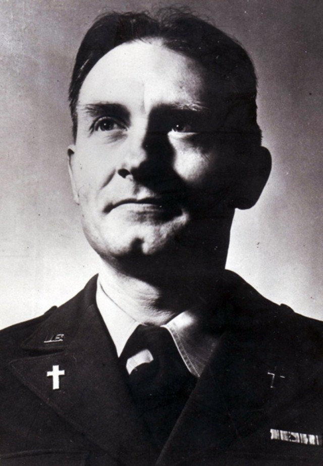 Chaplain (Capt.) Emil J. Kapaun posing for a portrait, the symbol of the cross prominently displayed on his lapels.