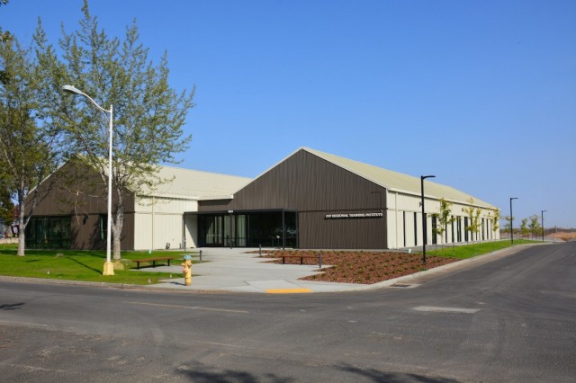 The recently completed Regional Training Institute Classroom building provides the needed classroom space for Soldiers training at Camp Umatilla, Oregon. The RTI building is situated adjacent to the administrative portion of historic district and can be seen from within the district.  Modern architectural styling clearly states the building is not included in the historic district, but muted, earth tones allow the RTI building to subtlety stand apart without being overbearing.  