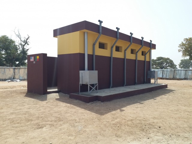 A multi-compartment ventilated improved pit latrine is seen here at the newly constructed health clinic site in the village of Godjekoara, Benin in Africa. The health clinic was one of two recently completed in the region by the U.S. Army Corps of Engineers, Europe District in support of AFRICOM and coordinated with the U.S. State Department. Both clinics feature similar latrine facilities, which are a type of specially designed latrines built in areas where is no dependable supply of piped water that feature ventilation pipes with built-in fly screens to reduce the gathering of flies and other disease carrying insects that often gather at restroom sites and are laid out to reduce lingering odors associated with their use. (Photo courtesy of Cosme Quenum)