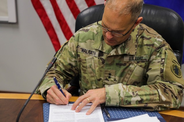 Maj. Gen. Daniel R. Walrath, Army South commanding general, signs the agreed-to-actions document between the U. S. and Salvadoran armies April 7, outlining future training commitments and professional exchanges between the two armies. (Photo by PFC Joshua Taeckens)