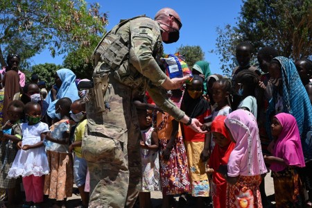 A soldier hands out candy to children in Lamu, Kenya, March 20, 2021. Soldiers collected donations from loved ones in the U.S. to support the humanitarian effort in the region.
