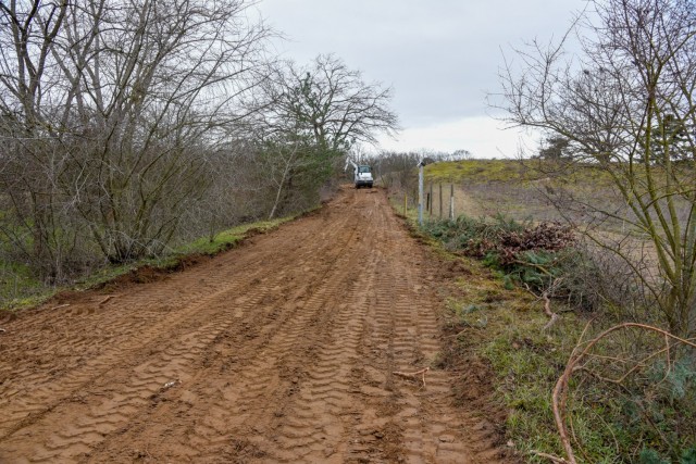 A contactor vehicle grades a path to expand and enhance a training site at the Mainz Sand Dunes Local Training Area near Mainz, Germany, Oct. 22, 2021 (U.S. Army photo by Alfredo Barraza)