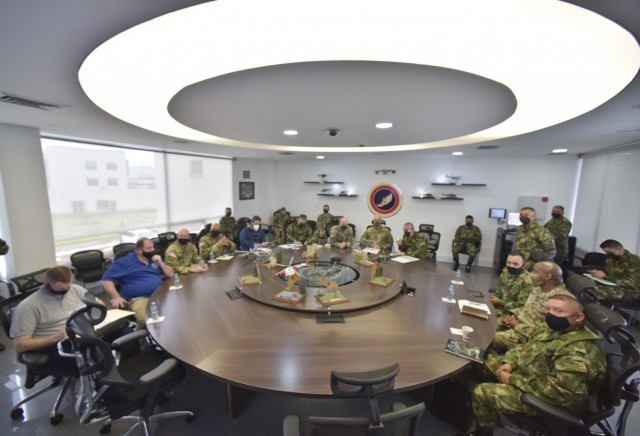 Maj. Gen.Elder Giraldo, chief of operations for the Columbian Army, center, briefs Brig. Gen. Douglas Lowrey, commander of U.S. Army Security Assistance Command, during a key leader engagement at the División de Aviación Asalto Aéreo headquarters in Bogota, Colombia, 6 April 2021. Lt. Col. Andrew Pesature, left, Army Chief of Missions at U.S. Embassy, provides translation services. Brig. Gen. Lowrey, and members of his staff, visited several sites to see the impact of U.S. security assistance and foreign military sales, in support of the Colombian military in defending their country from counter-narcotic and terrorist threats. (U.S. Army photo by Richard Bumgardner)