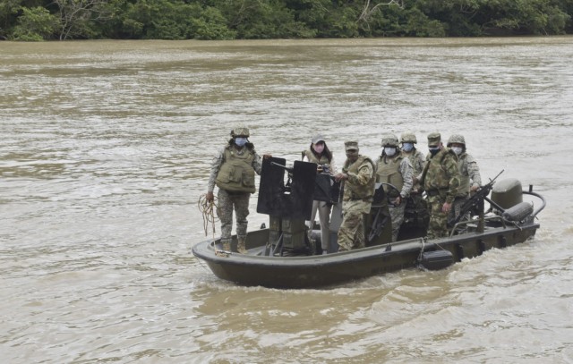 Command Sgt. Maj. Sean Rice, senior enlisted advisor at U.S. Army Security Assistance Command, rides in a boat that Colombian Marines use at a Colombian town in central Colombia, 5 April 2021. CSM Rice joined Brig. Gen. Lowrey, and members of his staff, as they visited several sites to see the impact of U.S. security assistance and foreign military sales, in support of the Colombian military in defending their country from counter-narcotic and internal terrorist threats. (U.S. Army photo by Richard Bumgardner)