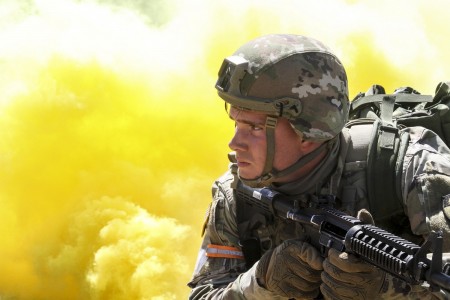 Army Spc. Caleb Romero, a California National Guardsman, scans his sector as smoke billows behind him during the mystery event of the California Guard’s Best Warrior Competition at Camp Roberts, Calif., March 31, 2021