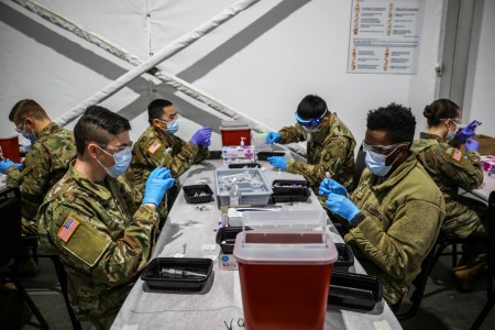 Soldiers prepare new batches of the COVID-19 vaccine at the United Center Community Vaccination Center in Chicago, April 1, 2021. U.S. Northern Command, through Army North, is committed to providing continued, flexible Defense Department support to the Federal Emergency Management Agency as part of the whole-of-government response to COVID-19.