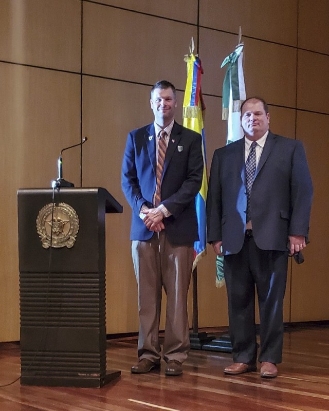 Joseph Kidwell Jr., left, the Senior Central Case Manager, and Jason King, the Country Program Manager, both from U.S. Army Security Assistance Command, pose for a photo after a training class at the Colombian National Police headquarters, in Bogota, Colombia. Kidwell and King conducted various training classes on the Foreign Military Sales process to 140 members of the Colombian Military, to include Colombian Army, Army Aviation, Air Force, Navy, Marines  National Police, Narcotics, and Ministry of Defense. Also in attendance was the Colombian vice Minister of Defense, Mr. Jairo García. (Courtesy photo)