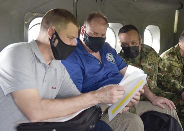 Joe Kidwell, left, the Colombian Central Case Manager at U.S. Army Security Assistance Command – New Cumberland, along with Jason King, center, the USASAC Colombian Country Program Manager, and their Colombian military counterpart, discuss foreign military sales cases during flight to see the Tolemaida Air Base, 6 April 2021. Kidwell, King and other members of the USASAC command leadership, visited several sites to see the impact of U.S. security assistance and foreign military sales, in support of the Colombian military in defending their country from counter-narcotic and terrorist threats. (U.S. Army photo by Richard Bumgardner)