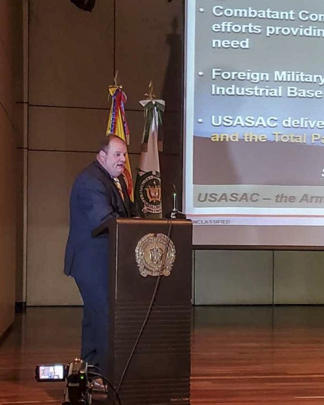 Jason King, the Country Program Manager, from Army Security Assistance Command, briefs the audience during a training class at the Colombian National Police headquarters, in Bogota, Colombia. King, and his counterpart from USASAC New Cumberland, Joseph Kidwell, conducted various training classes on the Foreign Military Sales process to 140 members of the Colombian Military, to include Colombian Army, Army Aviation, Air Force, Navy, Marines, National Police, Narcotics, and Ministry of Defense. Also in attendance was the Colombian vice Minister of Defense, Mr. Jairo García. (Courtesy photo)