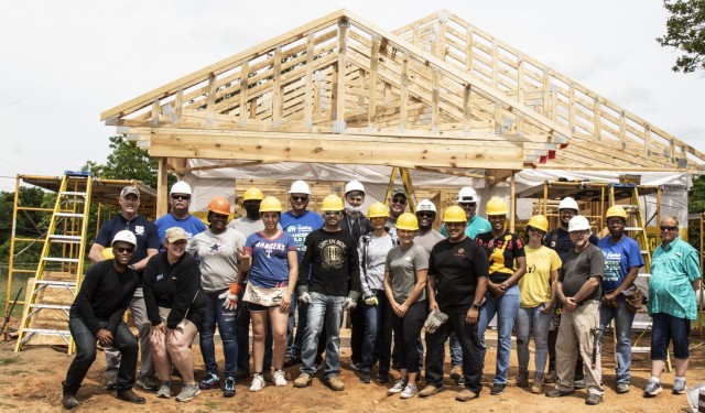 U.S. Army Reserve Soldiers assigned to the Mobilization Demobilization Operations Center (MDOC) from the
2-381st Training Support Battalion, 120th Infantry Brigade, First Army Division West, along with other volunteers, stand together for a group photo after completing the roof framing on a house construction site during a Habitat for Humanity housing project in Waco, Texas, May 16.  The participants from the MDOC team used this volunteering opportunity to frame a creative way for team and leadership building while also supporting the local community. (Courtesy Photo)