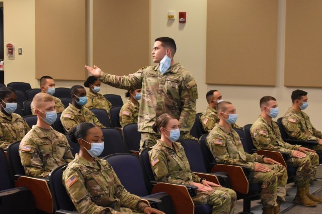 Pfc. Mason Calhoun, introduces his Family members during the Advanced Individual Training graduation ceremony for 56M, religious affairs specialist, of class 21-007 on May 13. (Photo by Mel Slater)