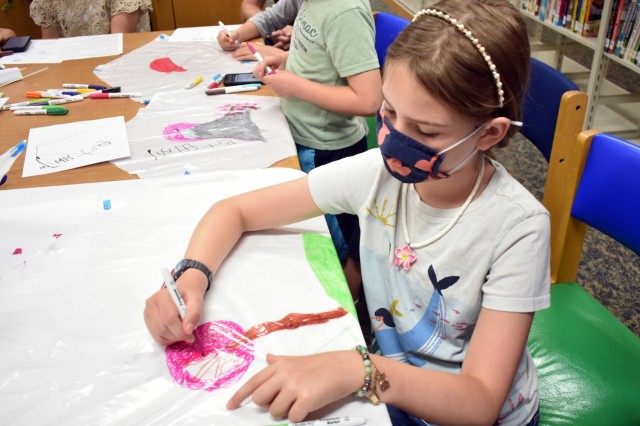 Sophie McWhorter, 9, makes a kite during a “Fun Friday” event at the Sagamihara Family Housing Area Library, SFHA, Japan, May 28.