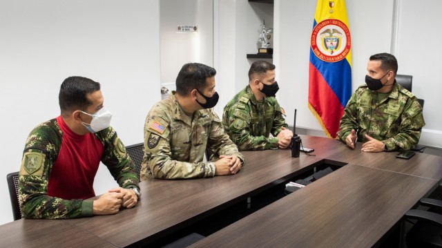 U.S. Army Chief Warrant Officer 3 Mauricio Garcia, meets with Lt. Col Milton Monroy, the Aviation Training Battalion commander, and staff at the Tolemaida Army Base, Colombia. Garcia, a UH-60M Black Hawk pilot and aviation safety officer, is deployed here as part of a technical advising team from Army Security Assistance Command’s Fort Bragg-based training unit, the Security Assistance Training Management Organization. (photo by Richard Bumgardner)