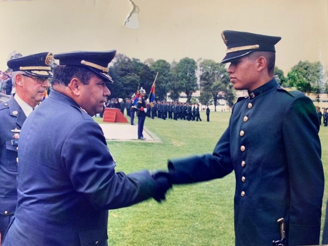 2nd Lt. Mauricio Garcia shakes hands with the school commander during graduation from a Colombian military officer school in Bogota, Colombia. Garcia, now a Chief Warrant Officer with the U.S. Army, is deployed to Tolemaida Army Base in Colombia as part of a technical advising team from U.S. Army Security Assistance Command’s Fort Bragg-based training unit, the Security Assistance Training Management Organization. (Courtesy photo)
12.01.2003