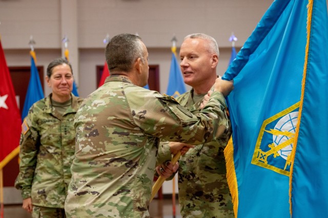 Military Intelligence Readiness Command (MIRC) Commanding General Brig. Gen. Joseph Dziezynski (right) passes the MIRC colors to Command Sgt. Major Brian Bertazon, MIRC senior enlisted leader, during the Military Intelligence Readiness Command's assumption of command ceremony, Fort Belvoir, Virginia, June 5, 2021. (U.S. Army Reserve photo by Maj. Jeku Arce)