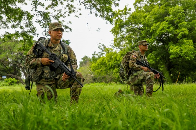 U.S. Army Staff Sgt. Ramiro Rangel, Army South Headquarters and Headquarters Battalion, and Spc. Justin Earnhart, 470th Military Intelligence Brigade, take a knee during the Army Futures Command Best Warrior Competition on Fort Sam Houston, Texas, June 9, 2021. The Best Warrior Competition evaluates a Soldier’s physical ability, tactical performance and knowledge of Army regulations. (U.S. Army photo by Pfc. Joshua Taeckens) (This photo was edited from its original version)