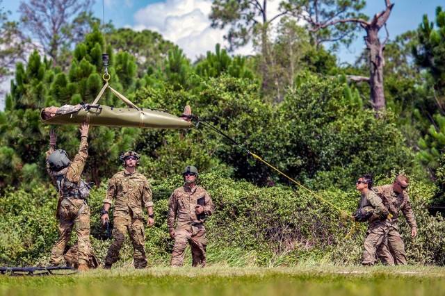 U.S. Air Force and Army medics hoist a medical manikin onto a UH-60 Black Hawk helicopter at MacDill Air Force Base, Fla., July 2, 2018. 