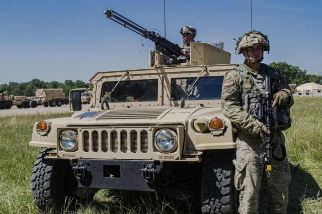Spc. Kevin Dempsey (left) and  Spc. Andrew Hogan, of the 702nd Engineer Company, stand guard at the vehicle entrance of tactical training base Justice as a part of Warrior Exercise 86-21-02 at Fort McCoy, Wis., June 9, 2021. 

WAREX is an annual training event integrating both combat support and combat service support assets to train United States Army Reserve Soldiers. The exercise facilitates opportunities to proactively handle real-world scenarios with competency in infantry tactics, defensive posture, vertical and horizontal construction, convoy operations and maintenance, communication planning and security, and media operations. (U.S. Army Reserve photo by Sgt. Michael Ito, 364th TPASE)