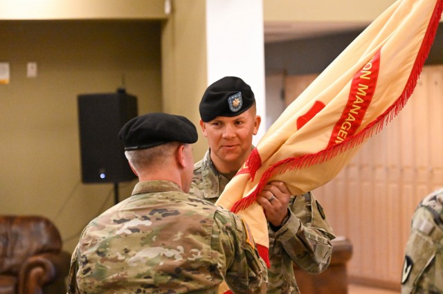 Incoming U.S. Army Garrison Alaska, Fort Greely Commander Lt. Col. Joey Orr receives the garrison colors from U.S. Army Garrison Alaska Commander Col. Christopher Ruga during the change of command ceremony June 24 at the Aurora Community Activity Center. The passing of the colors is a time-honored tradition that represents the transfer of authority from the outgoing commander to the incoming commander. 