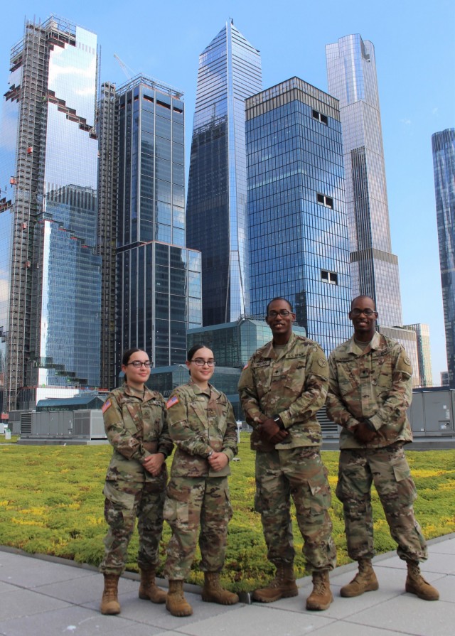 New York Army National Guard Spcs. Armani and Artez Wilkins, right, and Pfcs. Jiralmi and Gizelle Lugo, left, on the roof of the Jacob Javits Mass vaccination site in New York June 29, 2021. The two sets of identical twins have served together to support New York’s Operation COVID-19 response.  (U.S. Air National Guard photo by Maj Michael O&#39;Hagan)