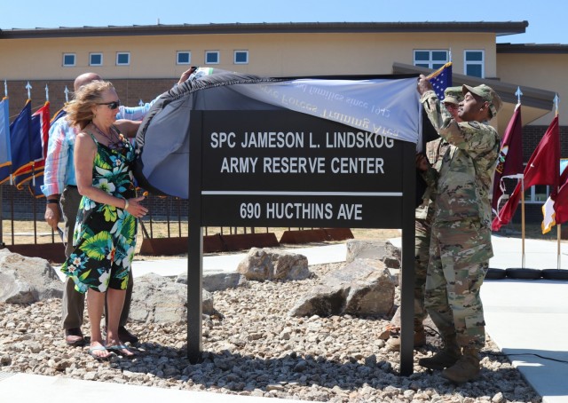 The Spc. Jameson L. Lindskog U.S. Army Reserve Center plaque is unveiled from left to right, by Mr. Curtis Lindskog, his father;  Mrs. Jo Lindskog, his stepmother;  Brig. Gen. Joseph Marsiglia, commanding general, Army Reserve Medical Readiness and Training Command and Maj. Gen. Jonathan Woodson, commanding general, Army Reserve Medical Command during the building memorialization ceremony, June 29, 2021 at Parks Reserve Forces Training Area in Dublin, Calif. Lindskog, a resident of Pleasanton, Calif., was killed in action March 29, 2011 while serving as a combat medic with the 2nd Battalion, 327th Infantry Regiment, 1st Brigade Combat Team, 101st Airborne Division in Afghanistan. He posthumously received the Silver Star for his heroic actions that day. 
(Photo by Sgt. 1st Class Matthew Chlosta)
