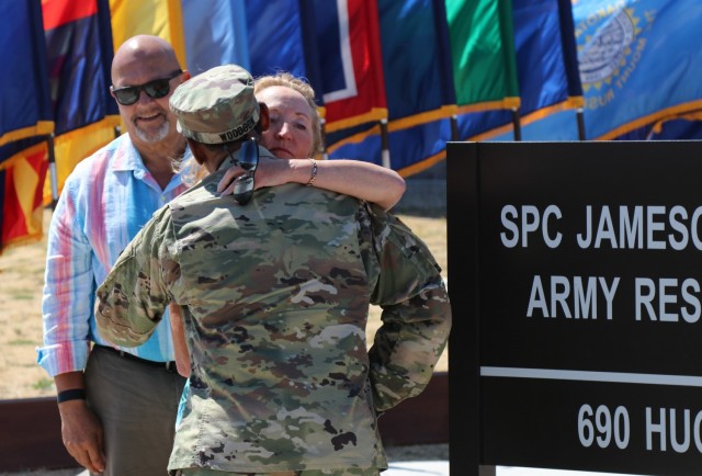 After the unveiling of the Spc. Jameson L. Lindskog U.S. Army Reserve Center plaque during the building memorialization ceremony, left, Mr. Curtis Lindskog, his father, pauses, as Maj. Gen. Jonathan Woodson, commanding general, Army Reserve Medical Command, embraces Mrs. Jo Lindskog, Lindskog&#39;s stepmother, as a show of support, June 29, 2021 at Parks Reserve Forces Training Area in Dublin, Calif. Lindskog, a resident of Pleasanton, Calif., was killed in action March 29, 2011 while serving as a combat medic with the 2nd Battalion, 327th Infantry Regiment, 1st Brigade Combat Team, 101st Airborne Division in Afghanistan. He posthumously received the Silver Star for his heroic actions that day. 
(Photo by Sgt. 1st Class Matthew Chlosta)