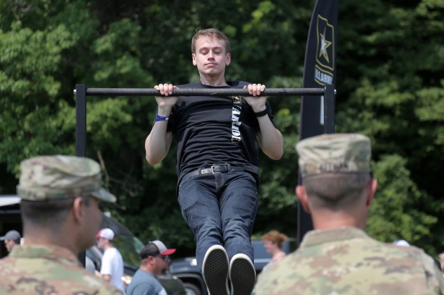 David Williams, from Oak Creek, Wisconsin, performs pull-ups during the Fourth of July NASCAR Cup Series race at Road America, Elkhart Lake, Wisconsin, July 4, 2021. The U.S. Army recruiting battalion, along with the Appleton Recruiting Company brought recruiters and displays from across their area to meet with citizens, allow them to experience Army technology and evaluate opportunities in military service. Brig. Gen. Ernest Litynski, Commanding General, 85th U.S. Army Reserve Support Command, attended the race as the Army’s senior leader and swore in 20 future Soldiers at the pre-race ceremonies.
(U.S. Army Reserve photo by Anthony L. Taylor)