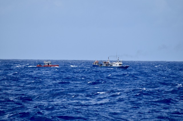 The crew of the Coast Guard Cutter Midgett (WMSL 757) aboard a small boat approaches a fishing vessel to conduct a fisheries law enforcement boarding in the Pacific Ocean on April 14, 2020. Midgett’s successful first patrol countering IUU fishing to promote maritime governance in Oceania is essential to U.S. national security and to support Pacific Island Forum countries whose resource security is vital to their own national security. (U.S. Coast Guard photo by USCGC Midgett/Released)