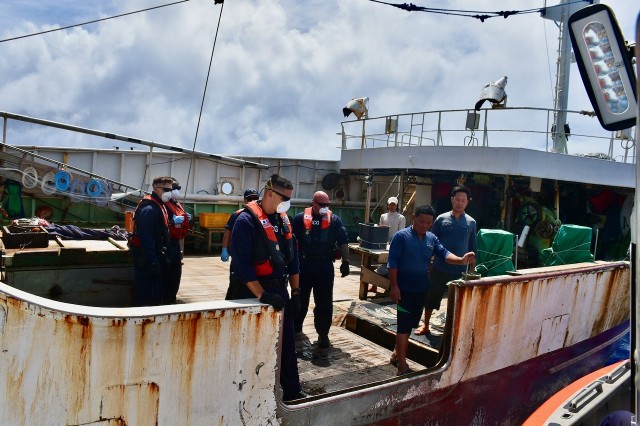 The crew of the Coast Guard Cutter Midgett (WMSL 757) boards a fishing vessel to conduct a law enforcement boarding to ensure compliance with international fisheries regulations and counter illegal, unregulated, and unreported (IUU) fishing in the Pacific Ocean, April 27, 2020. Midgett's crew protected U.S. fisheries by patrolling the U.S. Exclusive Economic Zone (EEZ) surrounding Johnston Atoll, Kingman Reef, and Palmyra Atoll. This action ensured U.S. presence to assure U.S. sovereignty and resource security in these remote regions. (U.S. Coast Guard photo by USCGC Midgett/Released)