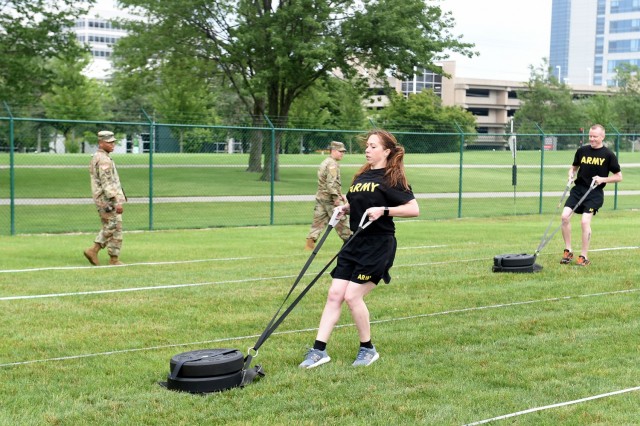 Staff Sgt. Alyssa N. Fowler, center, Human Resources Non-commissioned Officer, 84th Training Division, pulls a 90-pound sled during the Sprint-Drag-Carry portion of the Army Combat Fitness Test. The 85th USARSC conducted a diagnostic ACFT at its headquarters in Arlington Heights, Illinois July 10-11, 2021. The U.S. Army expects to fully implement the ACFT in 2022, replacing the 40-year old Army Physical Fitness Test.   
(U.S. Army Reserve photo by SSG Erika F. Whitaker)