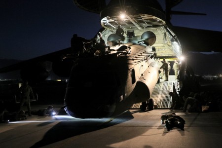 Aerial porters work with maintainers to load a CH-47 Chinook into a C-17 Globemaster III in support of the Resolute Support retrograde mission in Afghanistan, June 16, 2021.