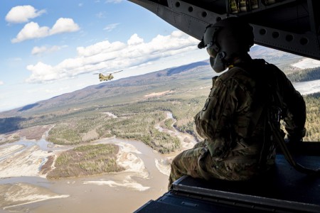A Soldier looks out from the back of an Army CH-47 Chinook during Northern Edge over Alaska, May 10, 2021. The exercise is designed to improve joint combat readiness.