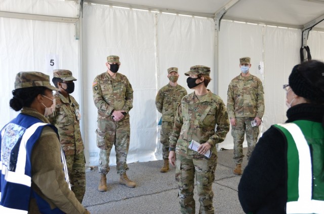 Brig. Gen. Paula Lodi, center, then-commander of Regional Health Command-Atlantic, visits with Soldiers at the Eisenhower Army Medical Center at Fort Gordon, Ga., in January 2021. Soldiers at Fort Gordon shifted some operations outdoors to follow COVID-19 safety protocols during pandemic restrictions. 