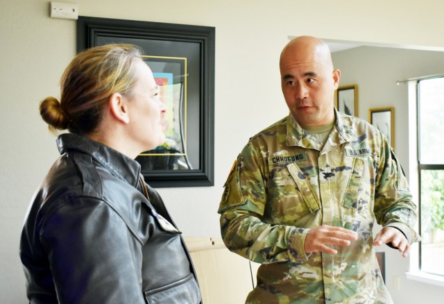 Col. Varman Chhoeung, commander of U.S. Army Garrison Presidio of Monterey, speaks with Air Force Lt. Col. Jen Whetstone, who is moving to Japan with her family, as movers pack up her household goods in Pebble Beach, Calif., July 16. Chhoeung accompanied a quality assurance inspector with the Presidio of Monterey Transportation Office to speak with service members and their families and ensure their permanent-change-of-station moves are going well.