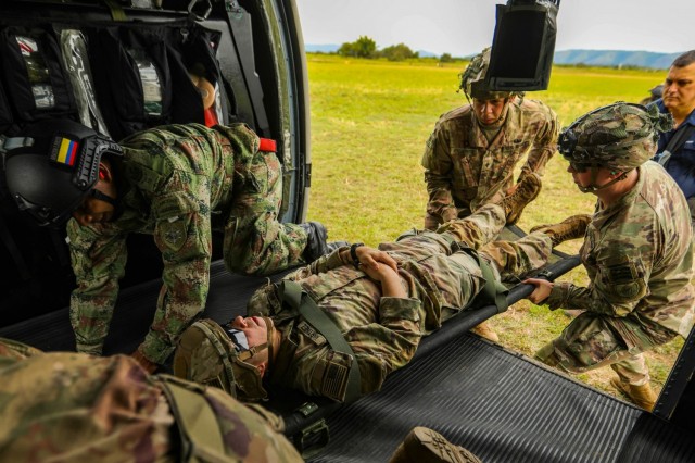 U.S. Army 82nd Airborne Division medics and a Colombian army combat medic conduct medical evacuation rehearsals in preparation for a combined airborne exercise July 24, 2021, at Tolemaida Air Base, Colombia. The U.S. Army and Colombian military conducted a Dynamic Force Employment airborne exercise, also known as Exercise Hidra II, involving jungle and water survival training, multiple airborne jumps and a field training exercise. (U.S. Army photo by Pfc. Joshua Taeckens)