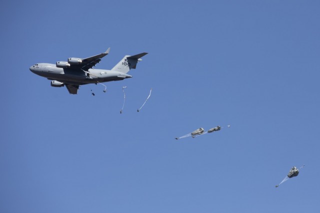 U.S. Army paratroopers with the 3rd Battalion, 509th Parachute Infantry Regiment, 4th Infantry Brigade Combat Team (Airborne), jump out of a Royal Australian Air Force C-17A Globemaster III onto a drop zone as part of a simulated Joint Forcible Entry Operation during Exercise Talisman Sabre 21 in Charters Towers, Queensland, Australia, July 28, 2021. A JFEO is a complex military operation that synchronizes multi-domain capabilities such as air, land, sea, information, space, cyberspace, and other domains to take possession of a key location in enemy territory and use it to introduce forces and capability to obtain military advantage enabling future operations. TS21 supports the U.S. National Defense Strategy by enhancing the ability to protect the homeland and provide combat-credible forces to address the full range of potential security concerns in the Indo-Pacific. (U.S. Army photo by Pfc. Matthew Mackintosh)