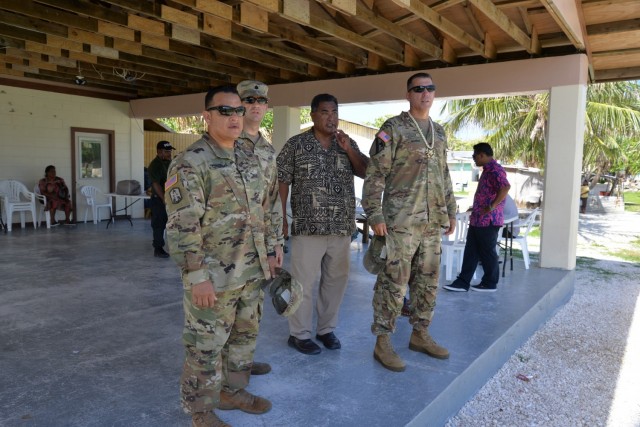 From left: USAG-KA Command Sgt. Maj. Ismael Ortega, USAG-KA Host Nation Director Lt. Col. Daniel Young, RMI Relations Specialist Mike Sakaio, USAG-KA Commander Col. Thomas Pugsley, and RMI Liaison Specialist Hilary Hosia stand at the Enniburr Evacuation Center during a visit to the island July 24, 2021.