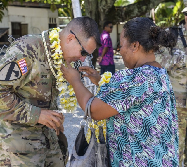 U.S. Army Garrison-Kwajalein Atoll Commander Col. Thomas Pugsley, receives a wut marmar from an Enniburr resident during his first visit to the island July 24, 2021.