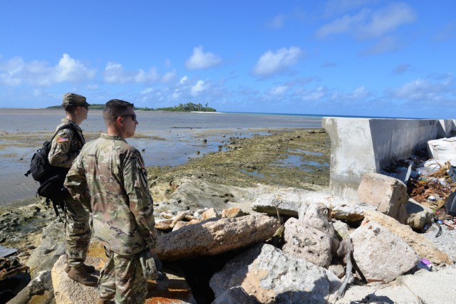 U.S. Army Garrison-Kwajalein Atoll Host Nation Director Lt. Col. Daniel Young, left, and USAG-KA Commander Col. Thomas Pugsley, right, view a seawall on western Enniburr during Pugsley's first visit to the island July 24, 2021. Built with funding from the Compact of Free Association, the seawall reduces flooding during typhoons and high tides.
