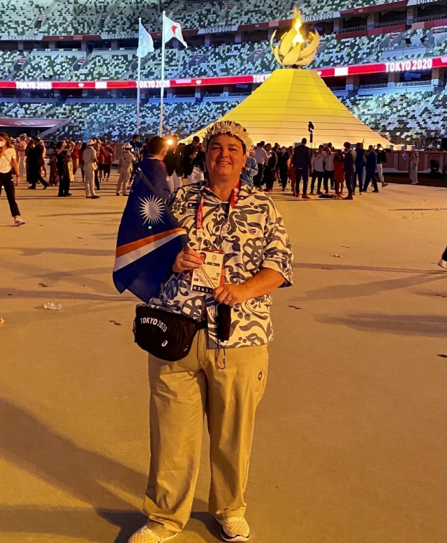 Chef de Mission Amy LaCost holds up the flag of the Republic of the Marshall Islands following the opening procession for the Summer Games in Tokyo July 23, 2021.