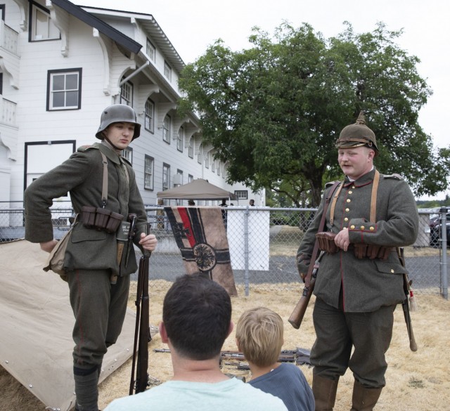 Huckleberry Hammer and Caleb Lundeen, living history historians and members of the PNW Great War speak to attendees about German military uniforms from World War I at the Lewis Army Museum living history exhibit at Joint Base Lewis-McChord, Wash., July 31, 2021.  Their uniforms depict a vast contrast between the start and the end of the war uniforms (U.S. Army photo by Spc. Nicole Nicolas).
