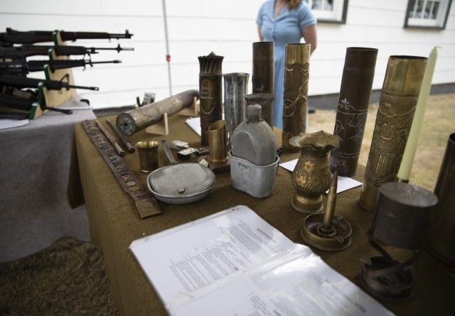 Alli Krisco, a living historian from Spanaway, WA displays Trench Art at the Lewis Army Museum reopening at Joint Base Lewis-McChord, Wash., July 31, 2021. Many soldiers during World War I created art pieces using artillery shells to pass the time (U.S. Army photo by Spc. Nicole Nicolas).