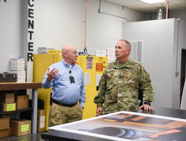 Maj. Gen. Daniel J. Christian, deputy chief of staff, U.S. Army Training and Doctrine Command, takes a tour with Enterprise Multimedia Center manager. This tour was in recognition of the EMC's outstanding efforts during the 2021 Remember the Fallen event.