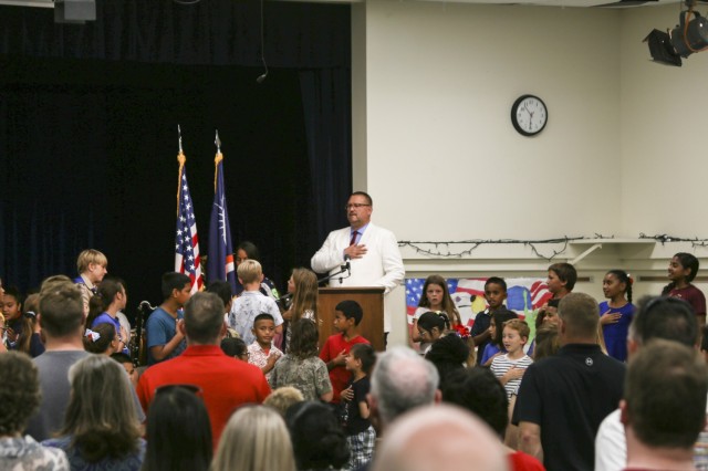 Kwajalein School System Head of School Paul Uhren, center, leads parents and students in the Pledge of Allegiance during the November 2020 Kwajalein School System Veterans Day Ceremony at the Davye Davis Multi-Purpose Room on U.S. Army Garrison-Kwajalein Atoll.
