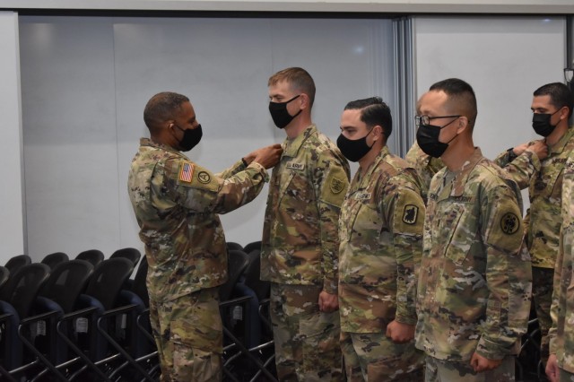 Chaplain School Commandant, Chap. (Col.) James Palmer, Jr. pins a Chaplain Basic Officer Leader Course 21-002 student with a regimental pin during the a pinning at the Chaplain School campus Aug. 6. By Mel Slater