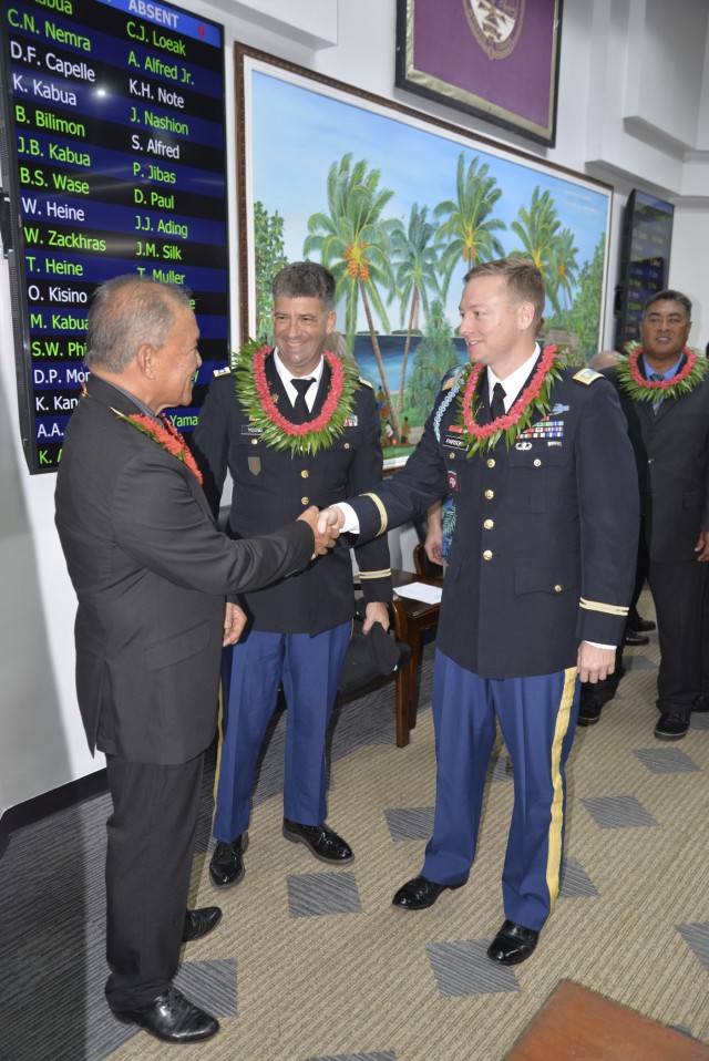 Republic of the Marshall Islands President David Kabua, left, greets outgoing USAG-KA Director of Host Nation Activities Lt. Col. Daniel Young, center, and incoming director Maj. Jay Parsons following the opening day of the Nitijela on Majuro Aug. 9, 2021.