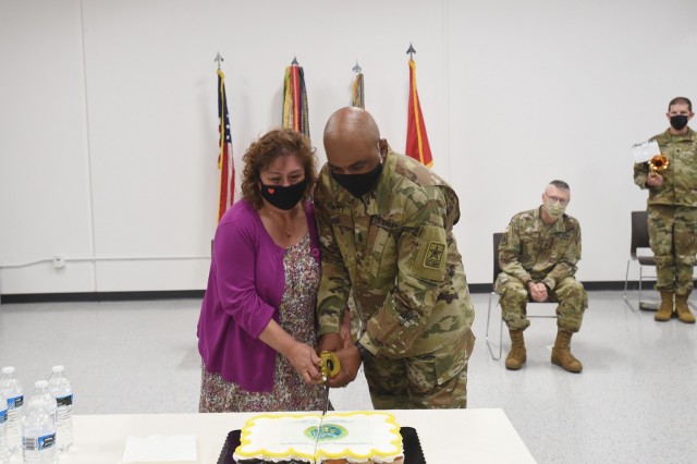 Command Sgt. Maj. Theodore H. Dewitt, outgoing command sergeant major for the 85th U.S. Army Reserve Support Command, along with his wife, Nancy, cut a ceremonial cake during his retirement ceremony, August 14, 2021. Dewitt retired from the U.S. Army after 36 years of service, culminating at the 85th USARSC.  
(U.S. Army Reserve photo by SSG Erika F. Whitaker)